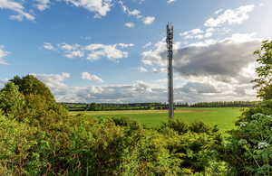 A photo of countryside with a mast