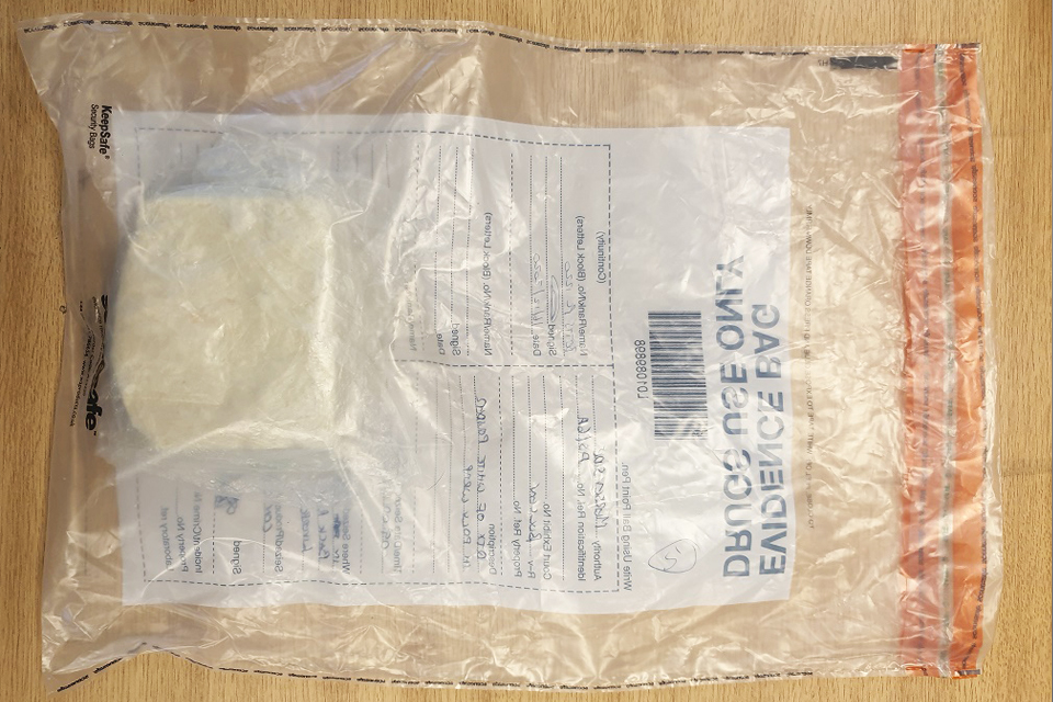 Evidence bag with clump of white powder.