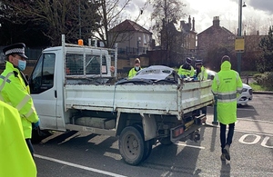 Picture shows a small lorrying containing metal car parts, which is surrounded by police and Environment Agency officers wearing high-visibility jackets
