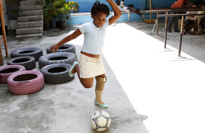 Renane, aged 8, plays football wearing her new prosthetic leg. Picture: Russell Watkins/DFID