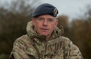 RAF Reservist Flight Lieutenant Mark Grange in full uniform smiling straight at the camera.