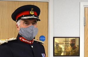Lord-Lieutenant of Fife Robert Balfour wearing a face mask dressed in full uniform standing next the plaque in the new centre.