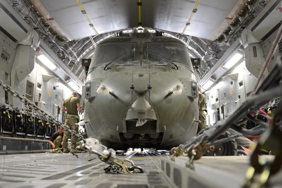A Merlin helicopter is packed and secured into an RAF C-17