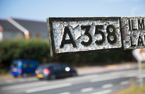 Road sign with A358 on it, with cars blurred in the background.