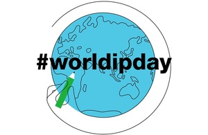 #World IP Day - A globe with a hand holding a pencil