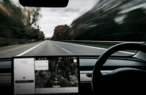 View of a road through a car windscreen.