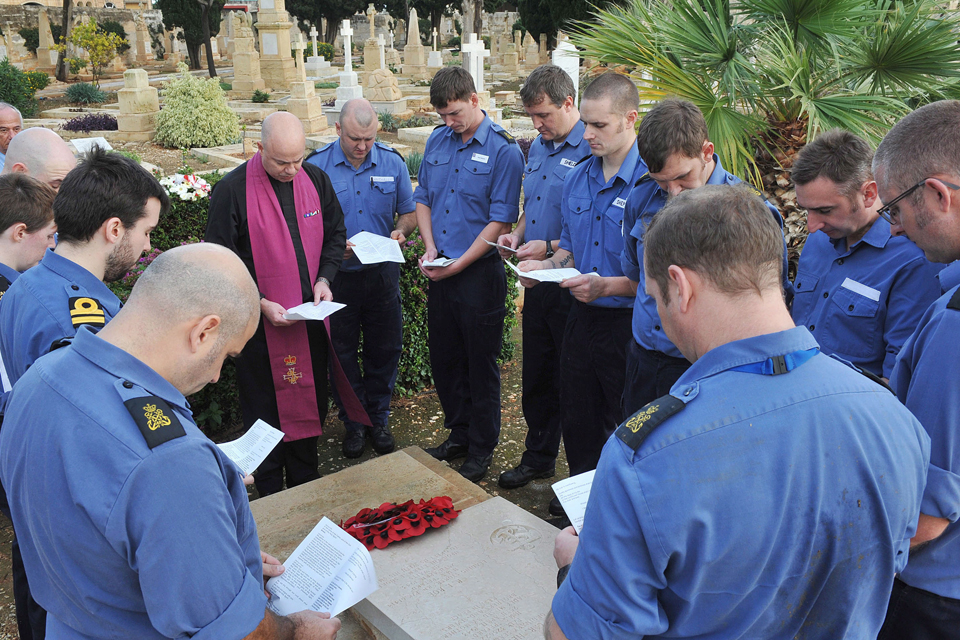 A commemoration service at the graves of 2 Illustrious crew members