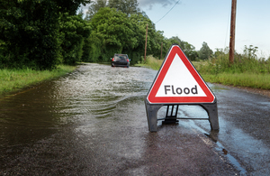 flooded road with flood signs