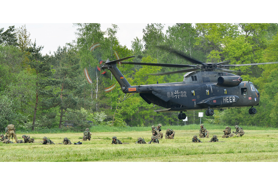 Soldiers disembark a German CH-53G Stallion helicopter