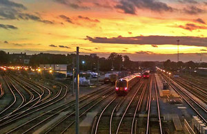 Train entering London Victoria Station at sunset.