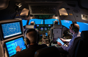 Personnel inside a C-17 flight simulator