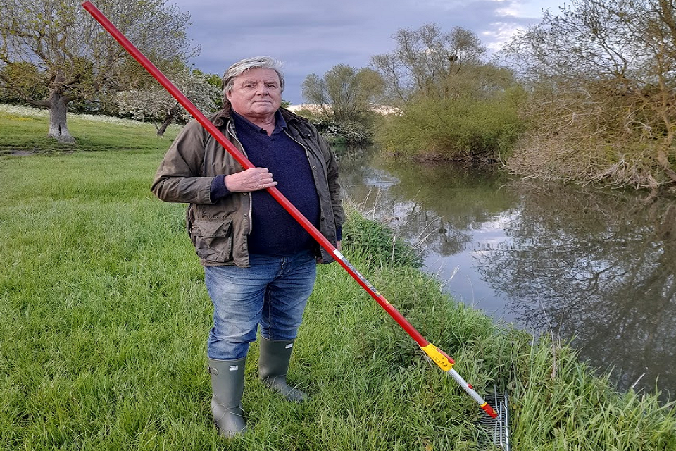 Mike Foley, a volunteer from Cam Valley Forum, standing on the riverbank.