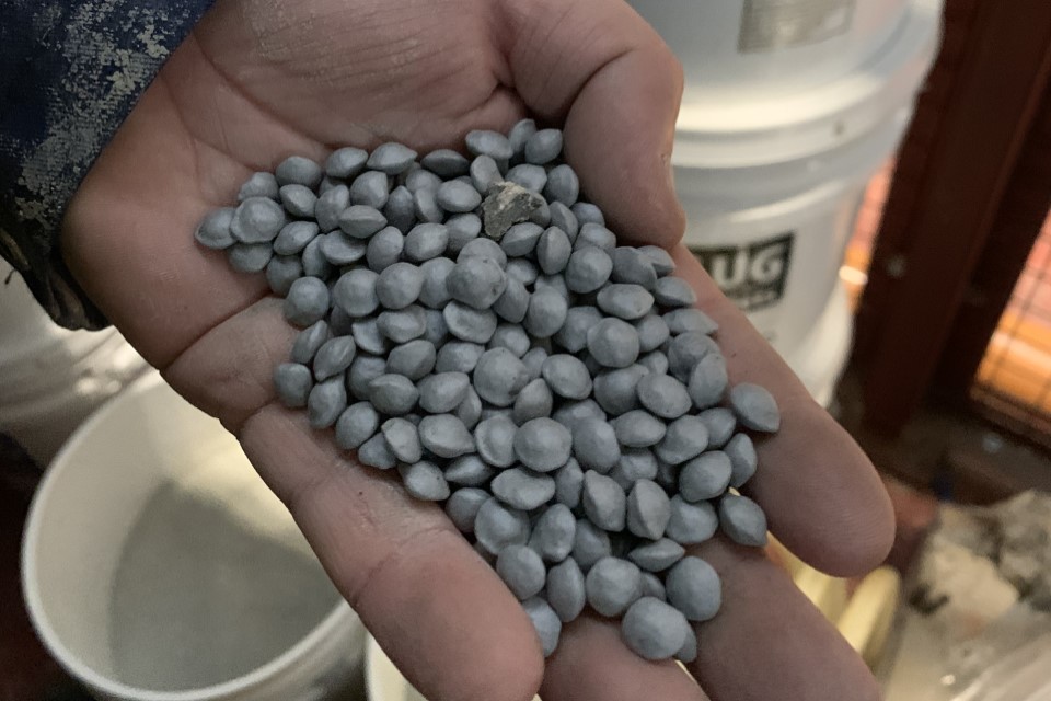 Bentonite pellets in a worker's hand