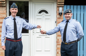 Air Cdre James Savage (left) presents the keys to his new SFA home at RAF Waddington, upgraded under Project Speed, to Chf Tech Brindley. This is the first RAF move in under Project Speed. (Crown Copyright, MOD2021)