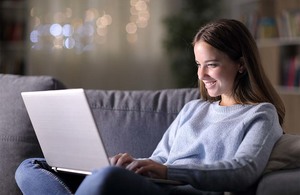 Lady watching programmes on a laptop