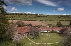 Image of a village with green fields surrounding