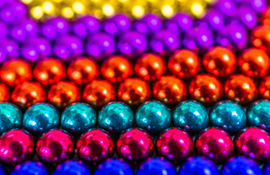 Rows of spherical magnets in bright colours.