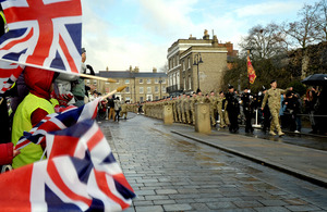 Crowds cheer passing soldiers