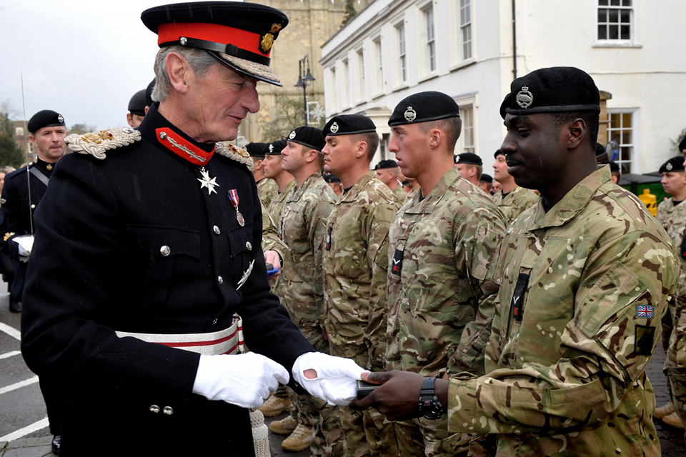 Lord Tollemache presents a soldier with a medal