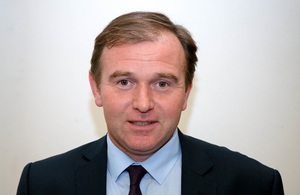 Portrait photograph of Rt Hon George Eustice MP in a suit and tie