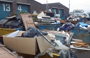 Image shows a large amount of mixed waste on the site of the industrial units