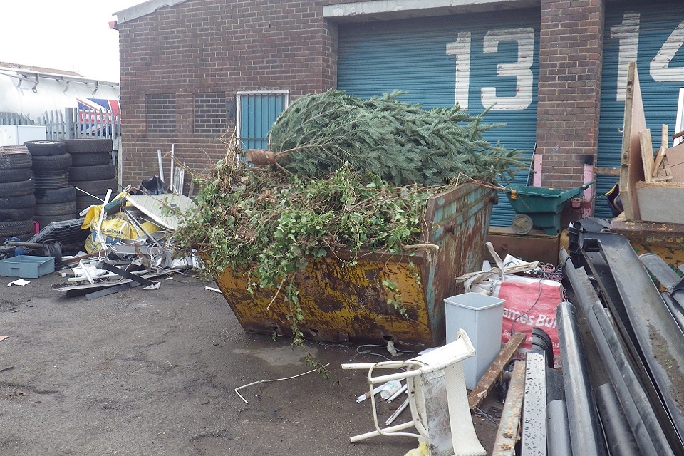 Image shows Christmas tree waste at the site of the industrial units as well as other waste. 