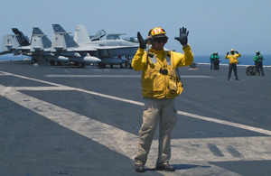 Aircraft handlers on board US aircraft carriers are trained to co-ordinate a continual stream of aircraft as they prepare to fly or come into land on the deck [Picture: Crown copyright]