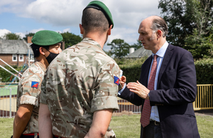 Minister for Defence People and Veterans Leo Docherty in a playpark speaking with uniformed Army personnel