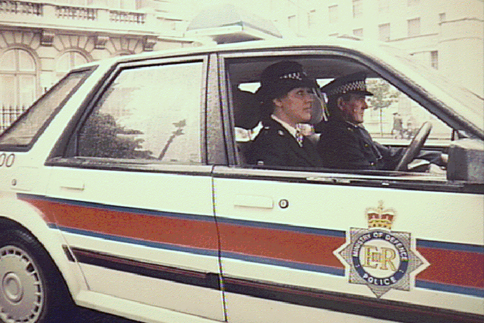 MOD police officers in a vintage MOD police car on Whitehall.