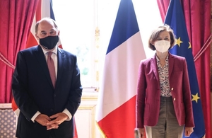 Ben Wallace and Madame Parly stand socially distanced in front of the UK and French flags with their Covid-19 face masks on