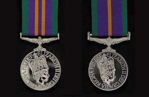 A close-up of 2 medals on ribbons.