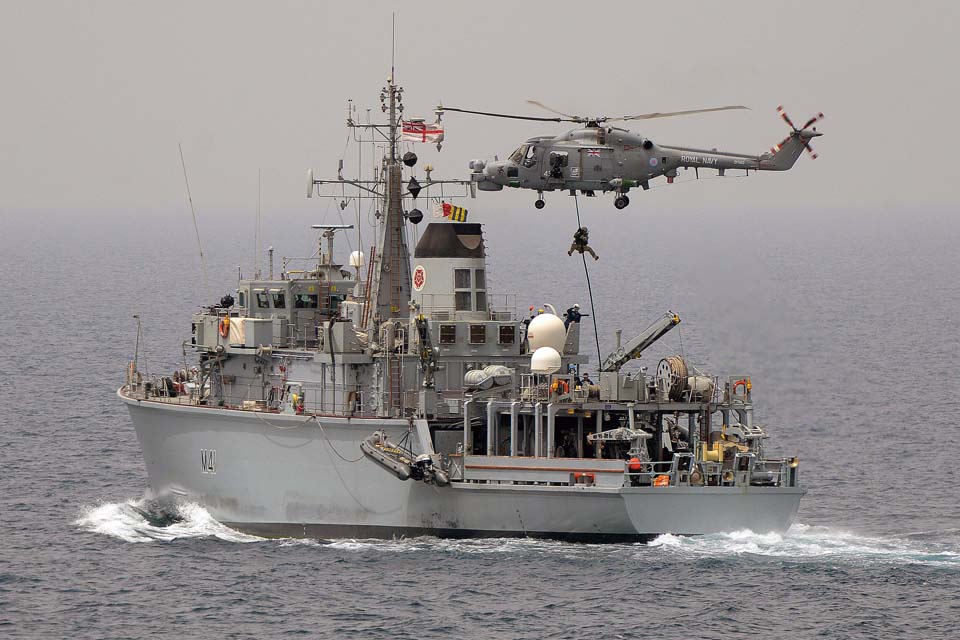 Boarding team fast ropes onto HMS Quorn