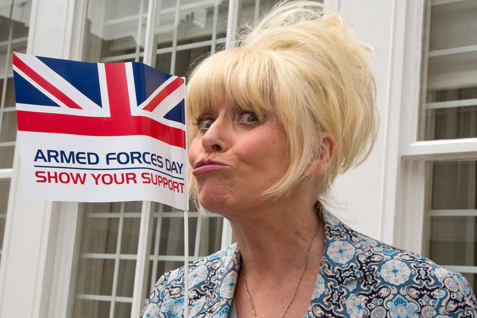 Barbara Windsor with an Armed Forces Day flag