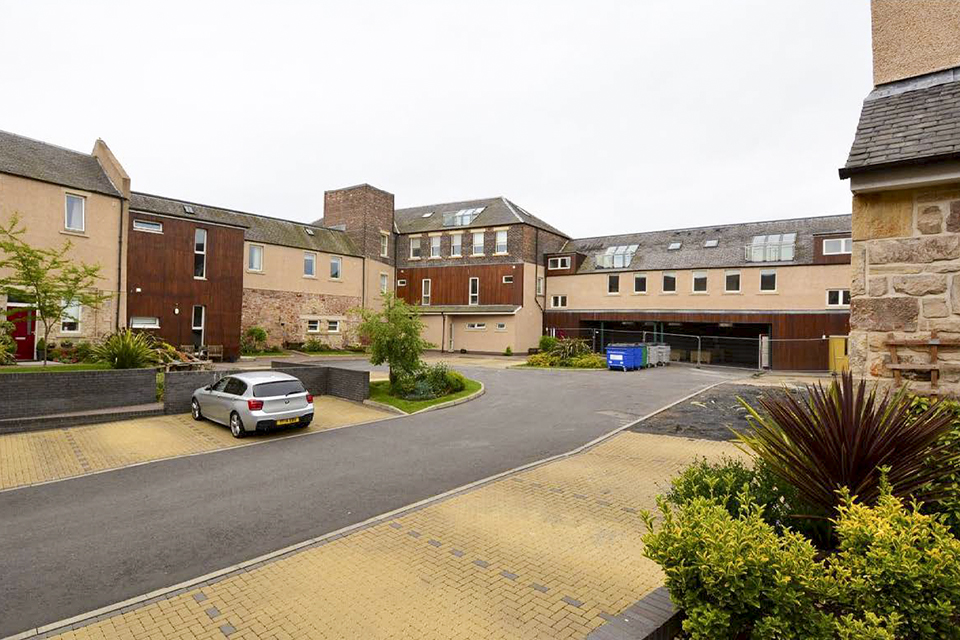 Allen Court at the start of the project, with the flats on the right fenced off