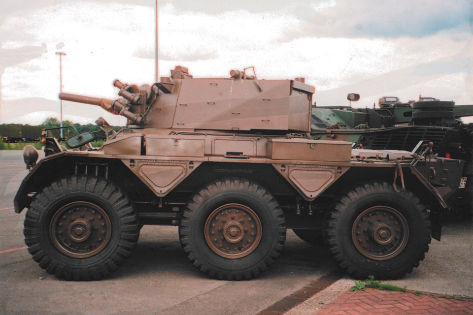 six-wheeled armoured vehicle in desert livery