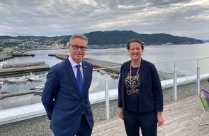 Minister Prentis and Norwegian Minister Ingebrigtsen with a port backdrop