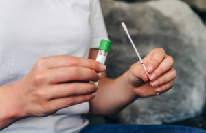 Person holding a swab to test for coronavirus
