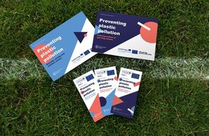 Leaflets about preventing plastic pollution laid out on grass