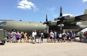 Aviation fans at the Bagotville Air Show queue to get on-board a C-130 Hercules tactical transport aircraft.