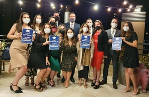 Group of twelve scholars and Ambassador Ramin Navai posing with the sign "I can't keep calm, I've been chosen for Chevening"