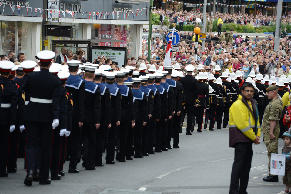 Armed Forces personnel parading through the crowded streets of Nottingham
