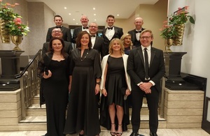Группа людей из цепочки поставок Sellafield Ltd., одетых в костюмы с черным галстуком, стояла группой перед церемонией награждения CIPS.