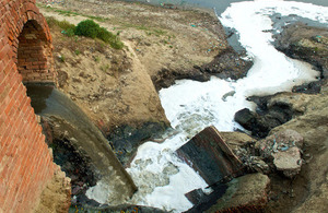 Raw sewage waste pouring into river