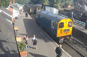 Platform webcam image of light locomotive travelling towards the stationary passenger train (image courtesy of North Yorkshire Moors Railway)