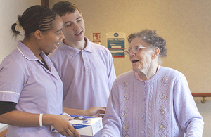 An older woman with two carers