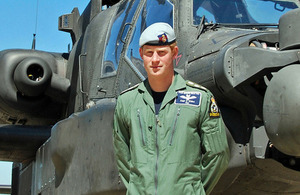 Captain Harry Wales standing in front of a British Army Apache attack helicopter [Picture: Sergeant B E Pearce, Crown copyright]