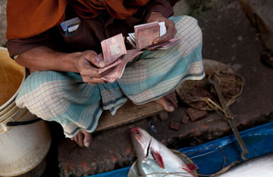 Counting money at a fish market in Khulna, Bangladesh. Picture: Mike Lusmore/ WorldFish