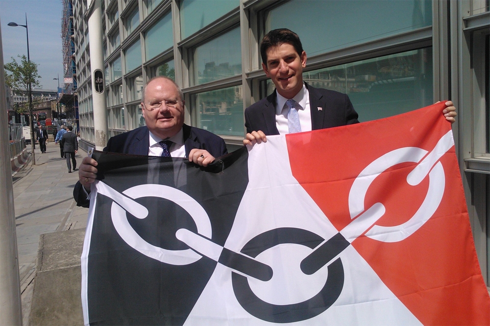 Secretary of State Eric Pickles and Chris Kelly MP hold the flag before it is raised on the flagpole