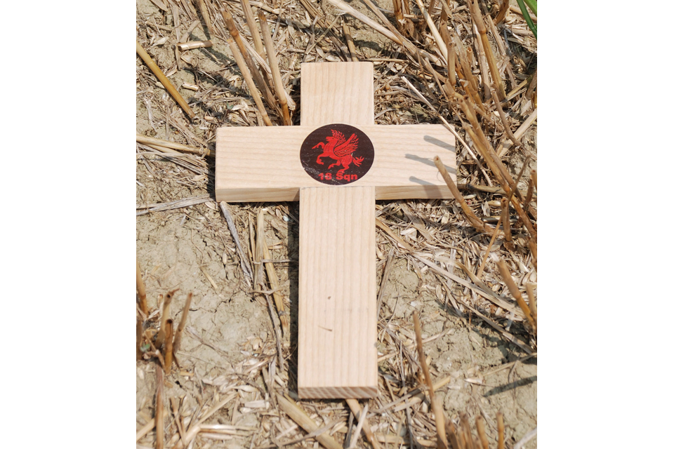 A simple wooden cross laid at the crash site of Boston BZ590