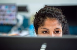 Woman sitting behnd computer screen